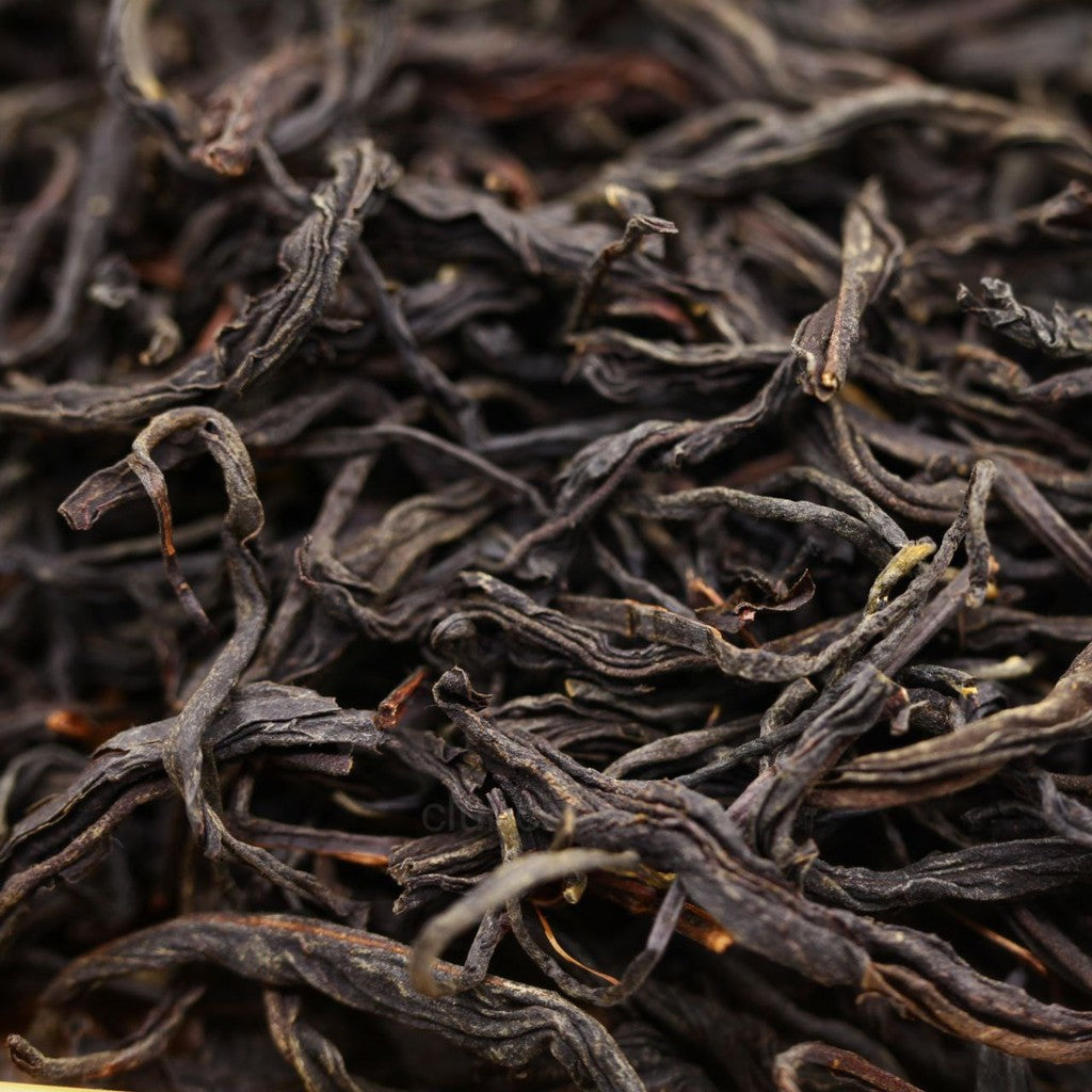 Twisted strands of premium Taiwanese red tea, deep amber and mahogany in color, representing Hong Lu Chu Chun – Red Nectar of First Spring, arranged loosely and photographed top-down.
